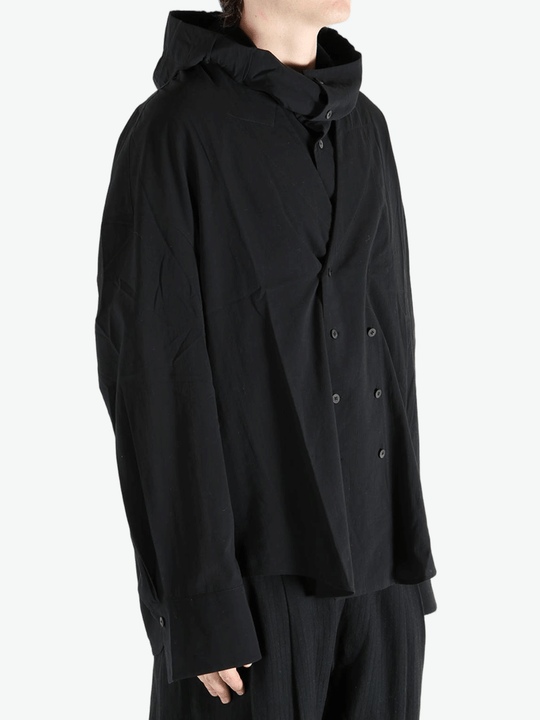 Black shirt worn by a person, showing the shirt's fit
