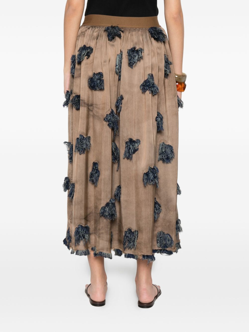 Brown skirt worn by a person, showing the skirt's fit