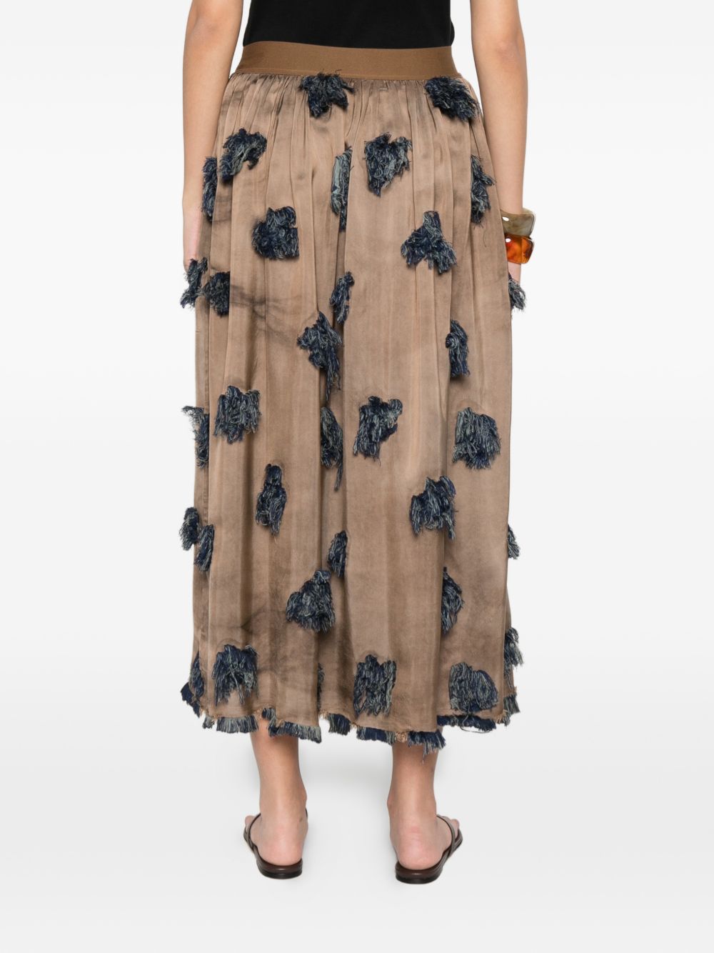 Brown skirt worn by a person, showing the skirt's fit