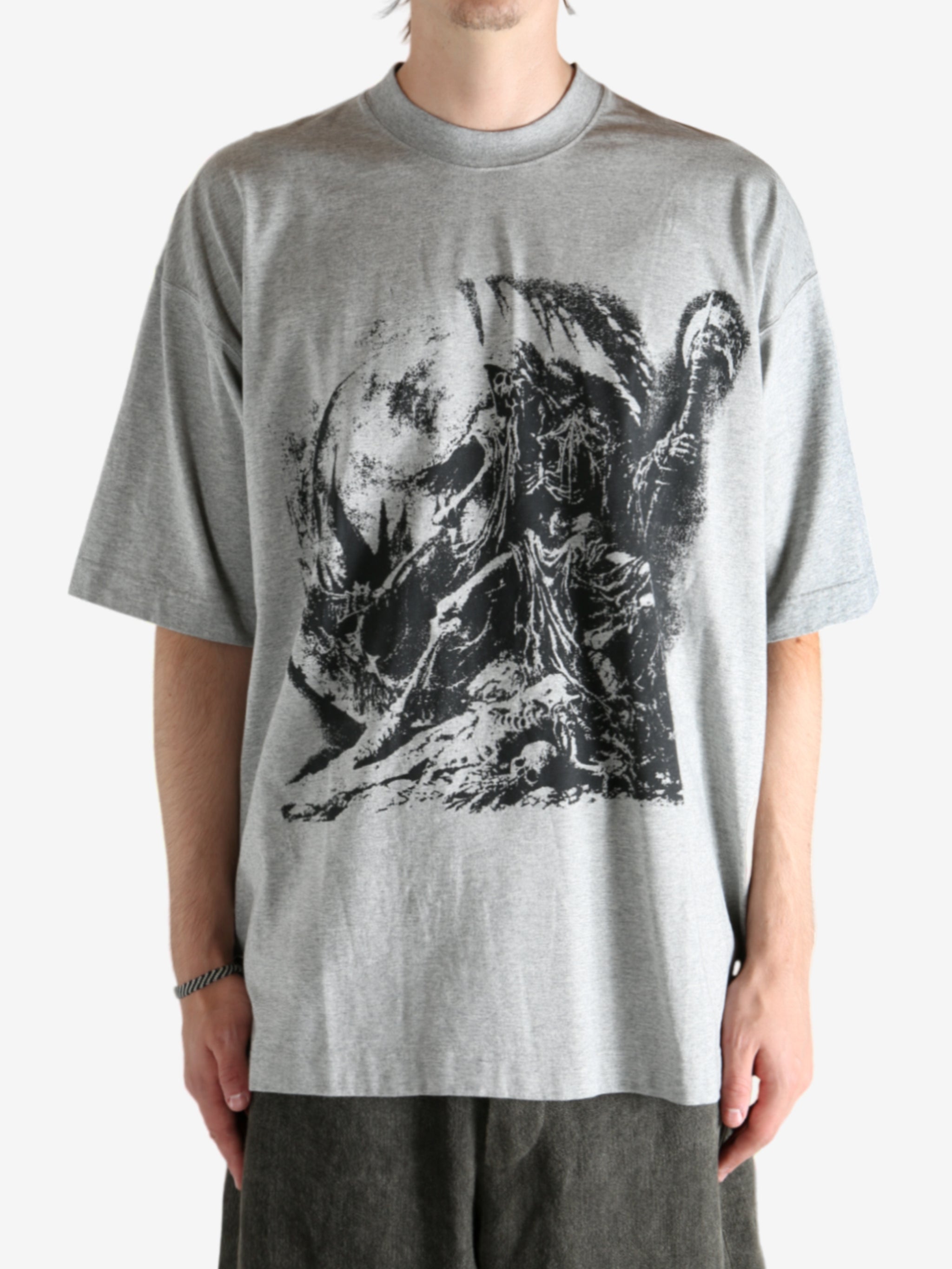 Grey t-shirt worn by a person, showing the shirt's fit