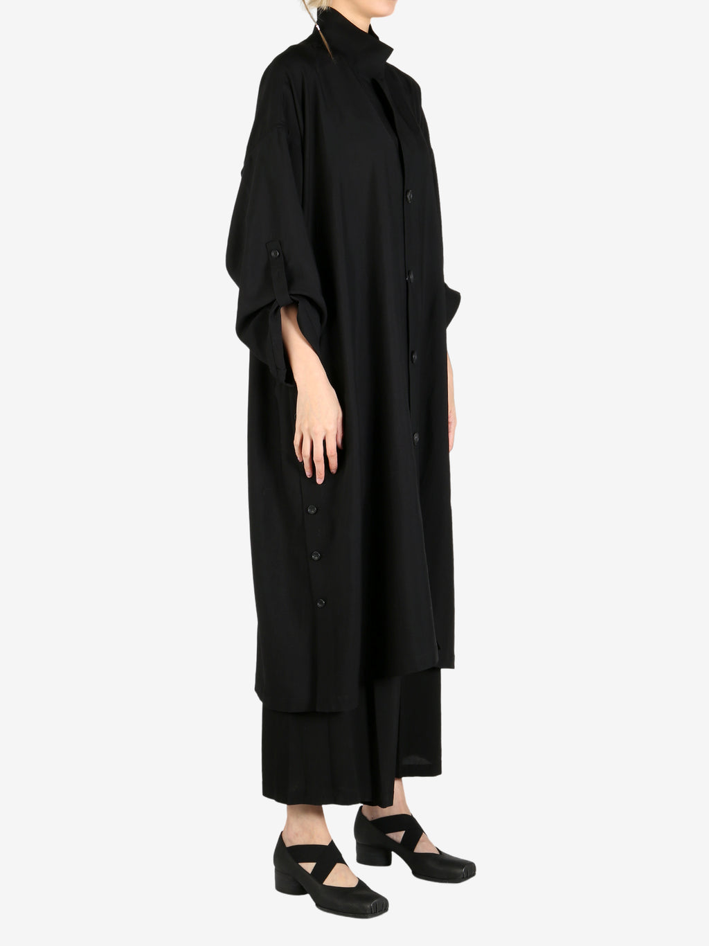 Black coat worn by a person, showing the coat’s fit