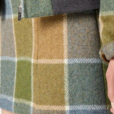 Close up of tan jackets, showing texture of the virgin wool fabric