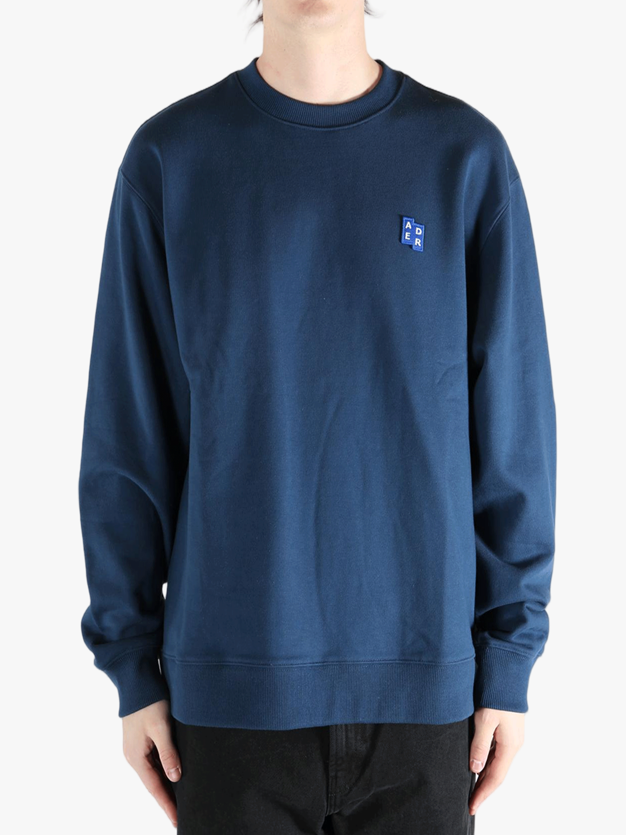 Navy sweater worn by a person, showing the sweater's fit
