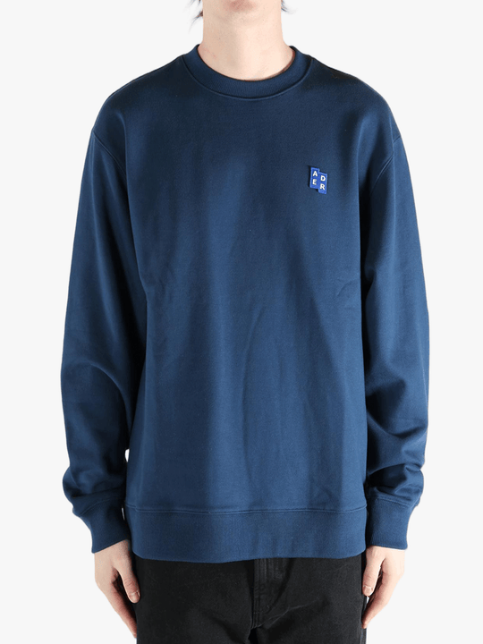 Navy sweater worn by a person, showing the sweater's fit