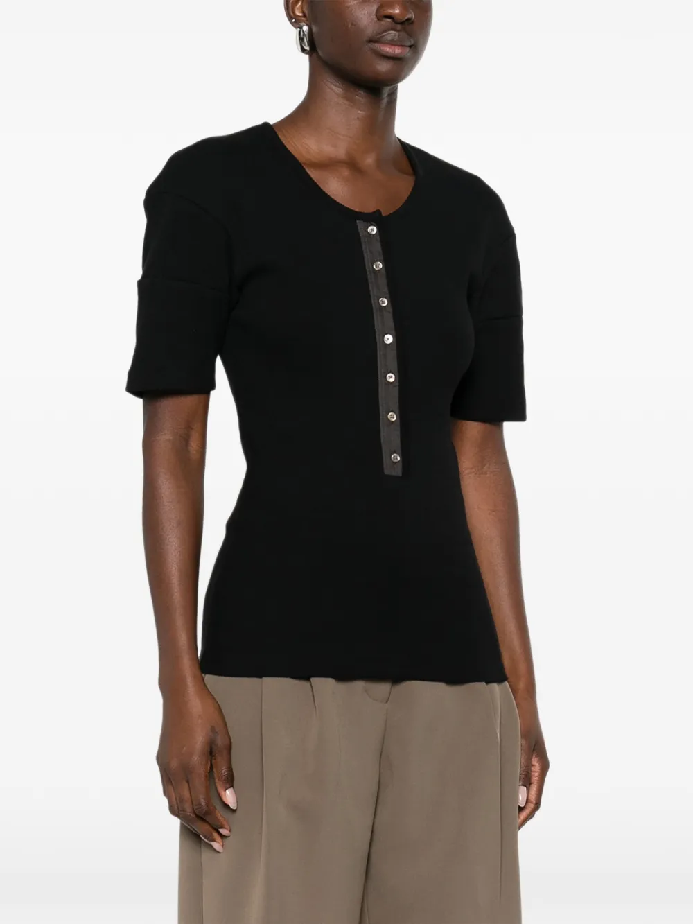 Black shirt worn by a person, showing the shirt's fit