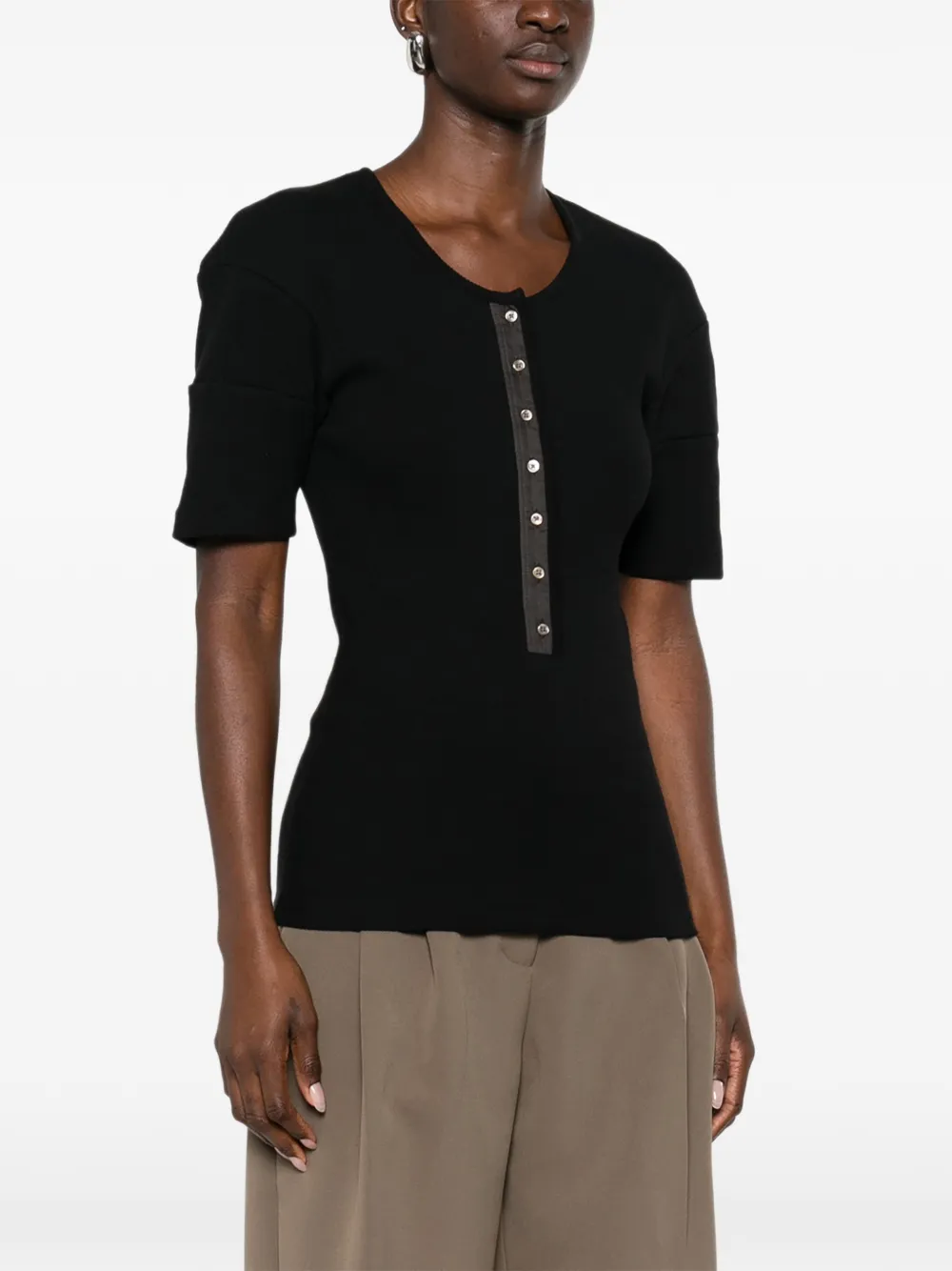 Black shirt worn by a person, showing the shirt's fit