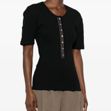 Black shirt worn by a person, showing the shirt's fit