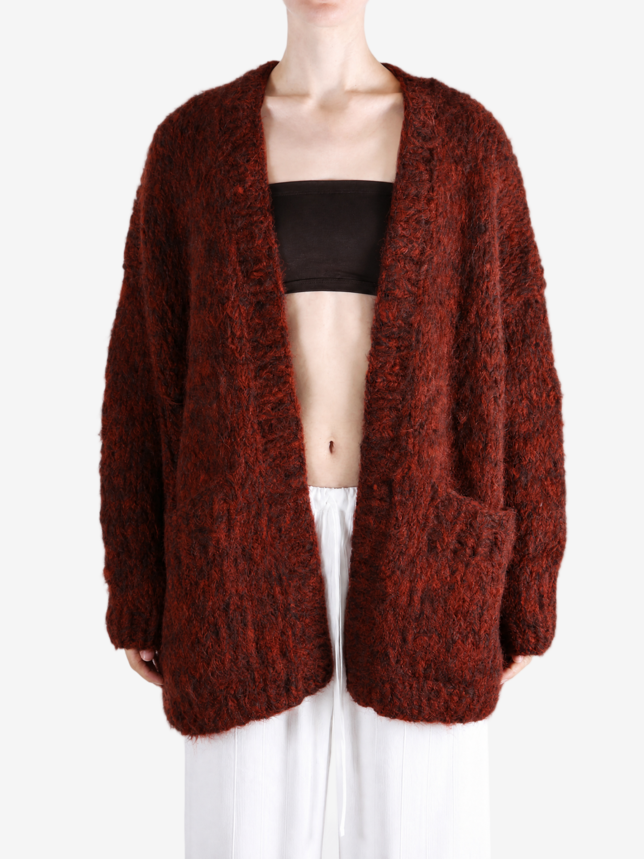Burgundy knitwear worn by a person, showing the knitwear fit