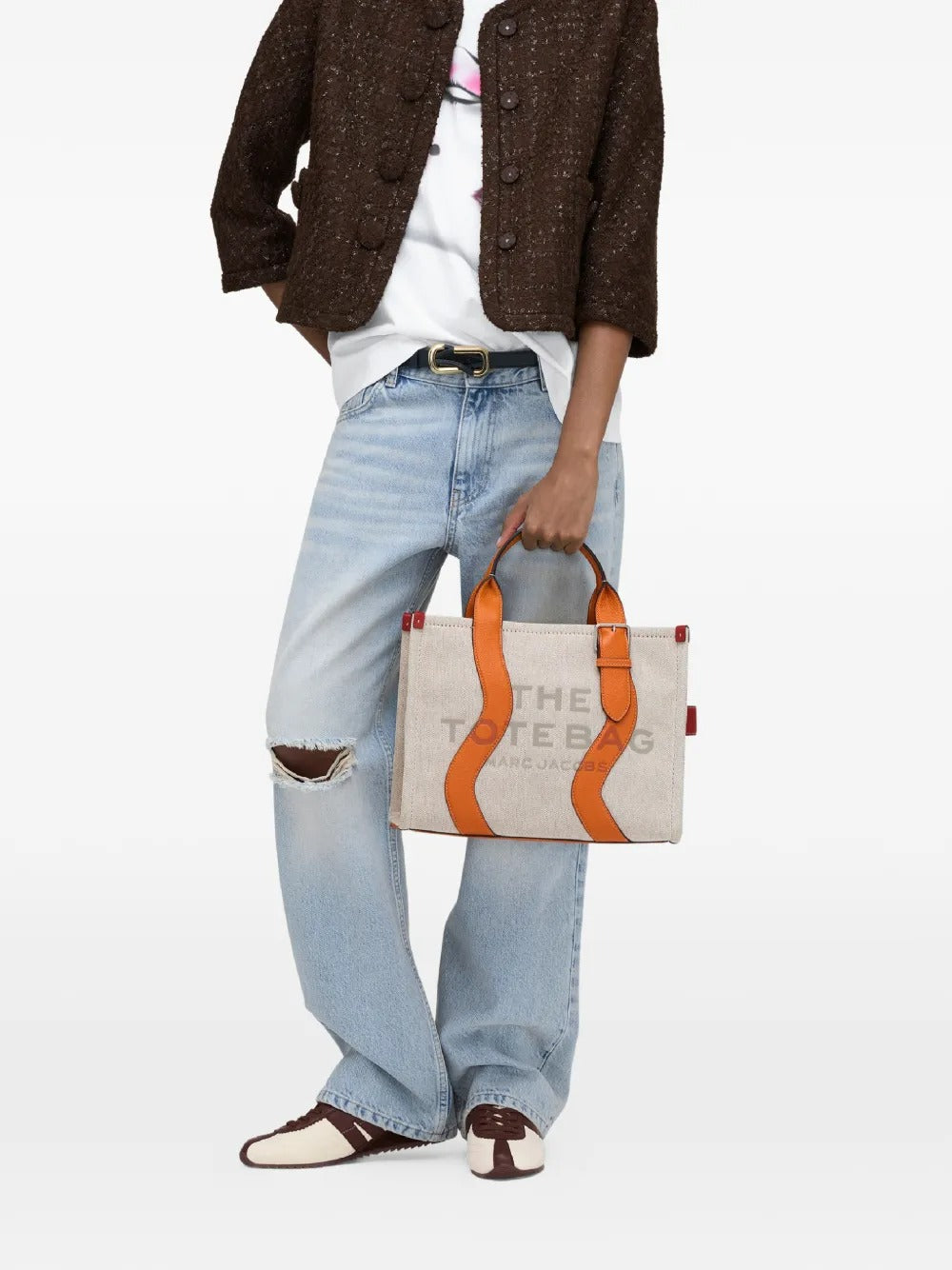 Tan bag worn by a person, showing the bag's fit