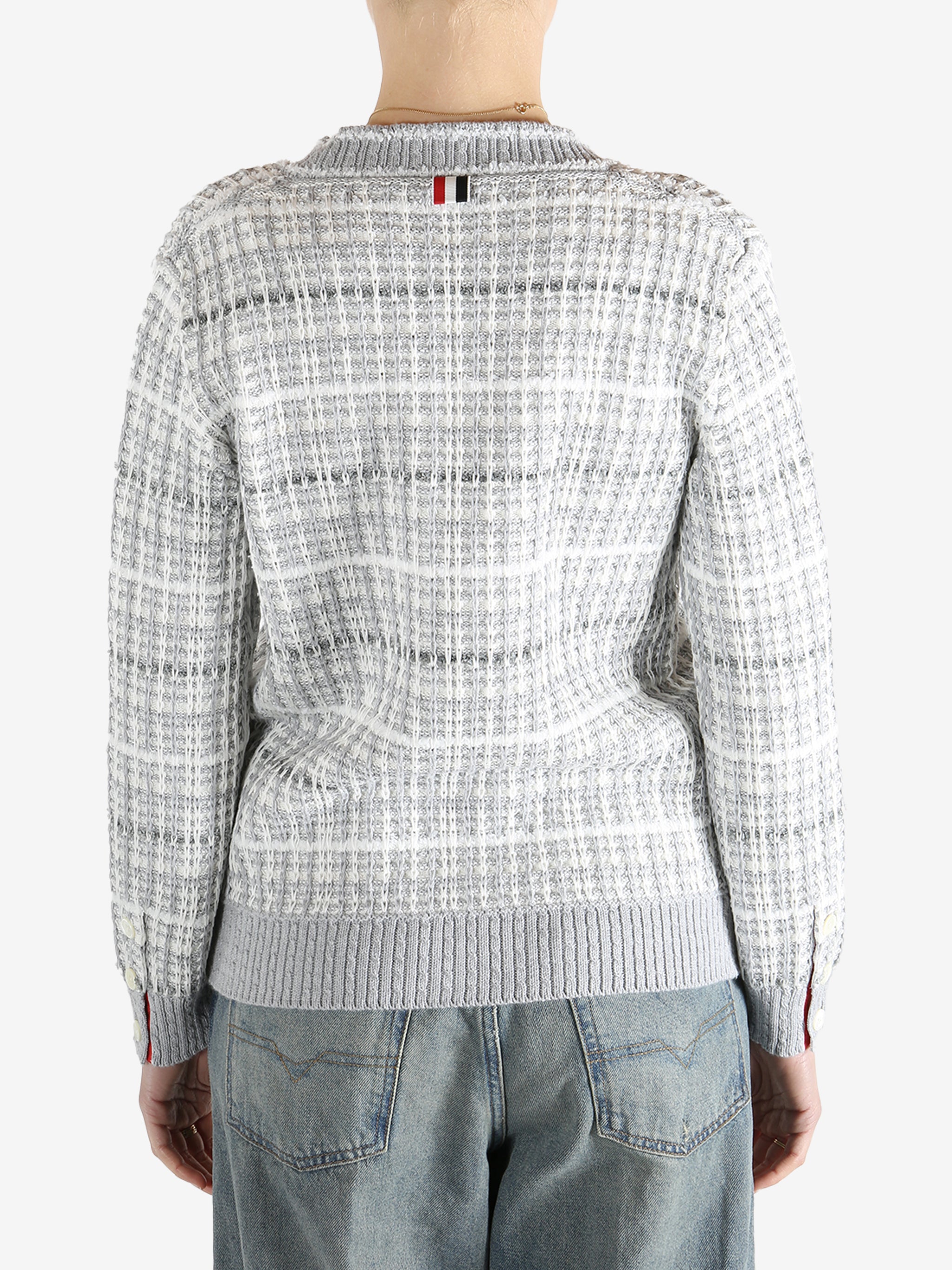 Grey knitwear worn by a person, showing the cotton fit