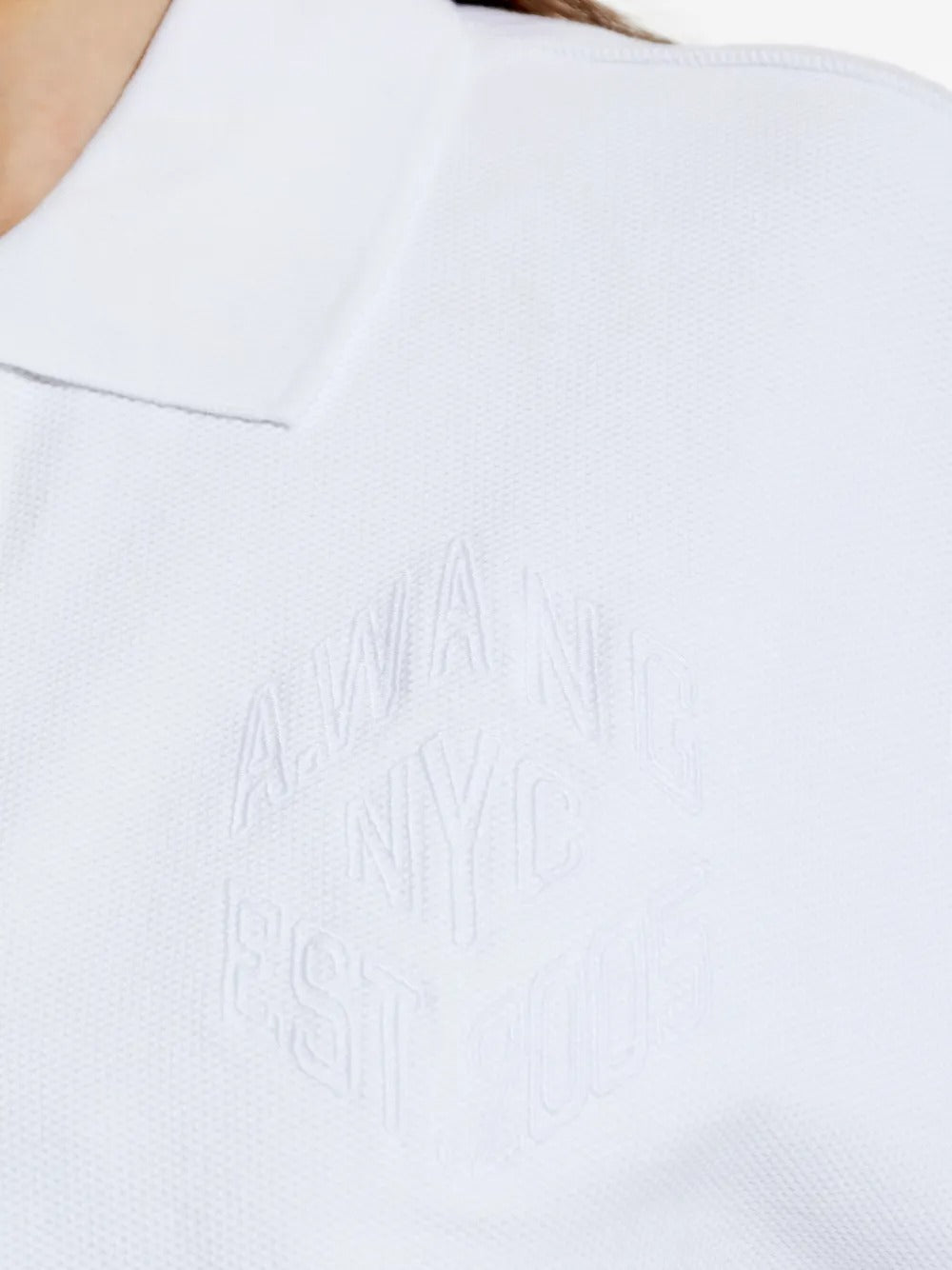Close up of the white t-shirt, showing texture of the cotton fabric