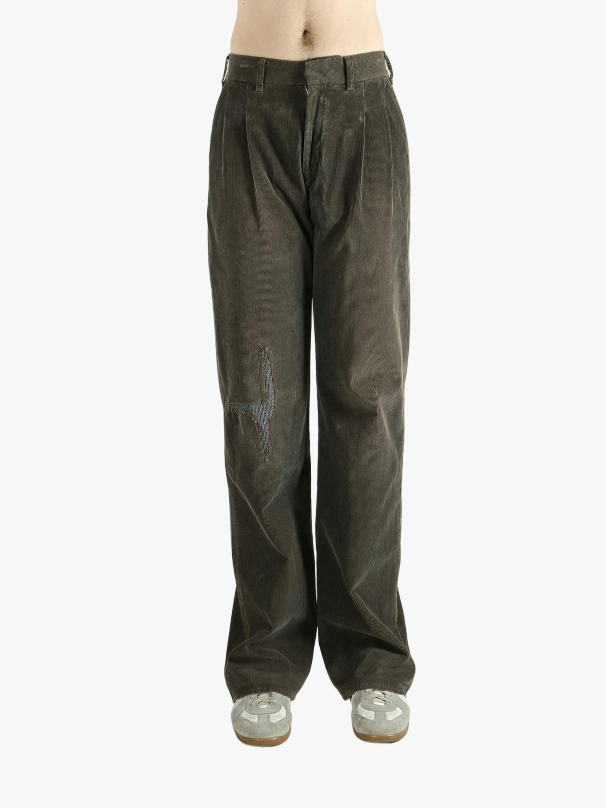 Brown pants worn by a person, showing the pants' fit
