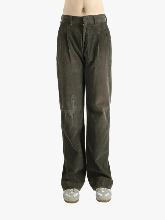Brown pants worn by a person, showing the pants' fit