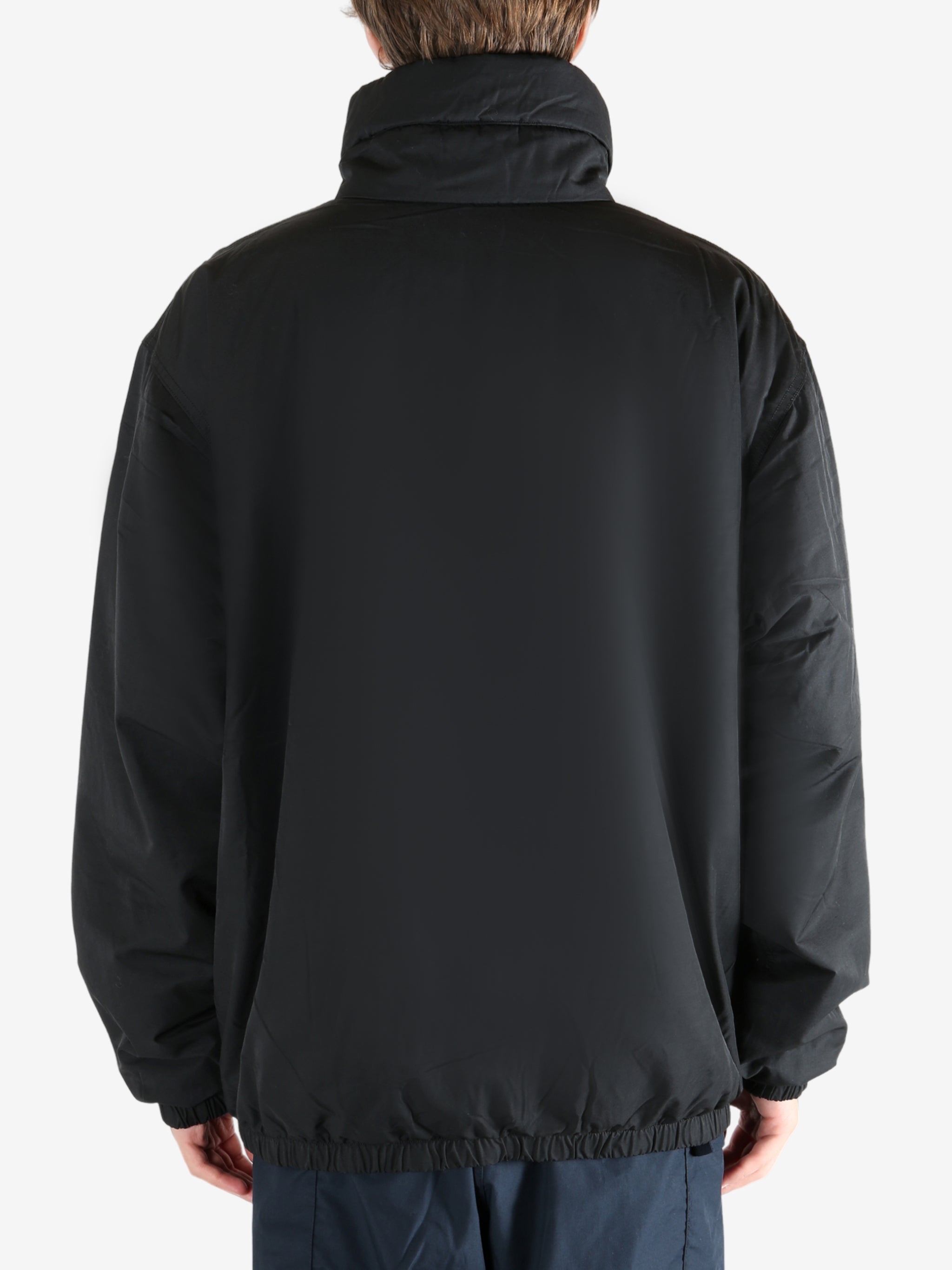 Black jacket worn by a person, showing the jacket's fit