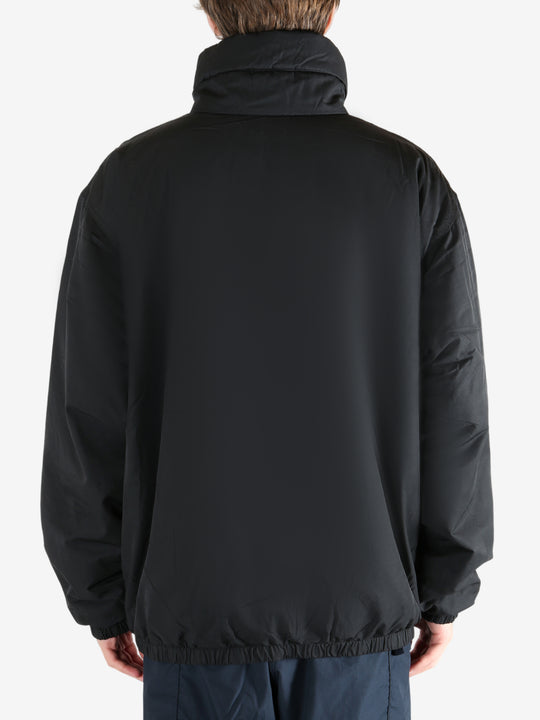 Black jacket worn by a person, showing the jacket's fit