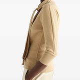Tan shirt worn by a person, showing the shirt fit