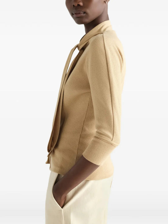 Tan shirt worn by a person, showing the shirt fit