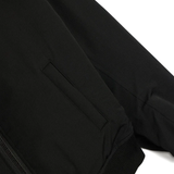 Close up of the black jacket, showing texture of the polyester fabric
