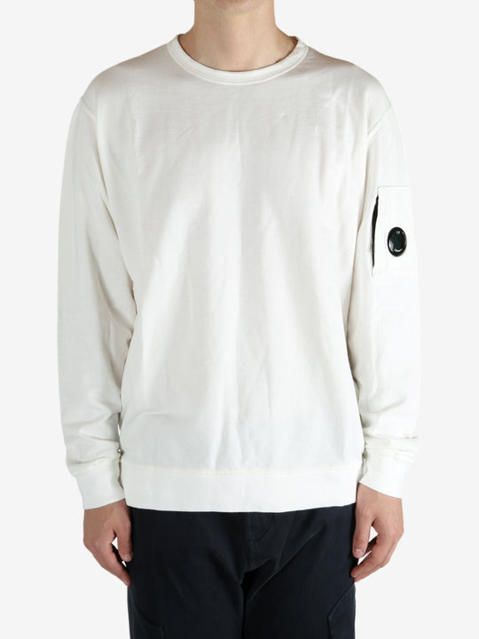 White crewneck worn by a person, showing the crewneck fit