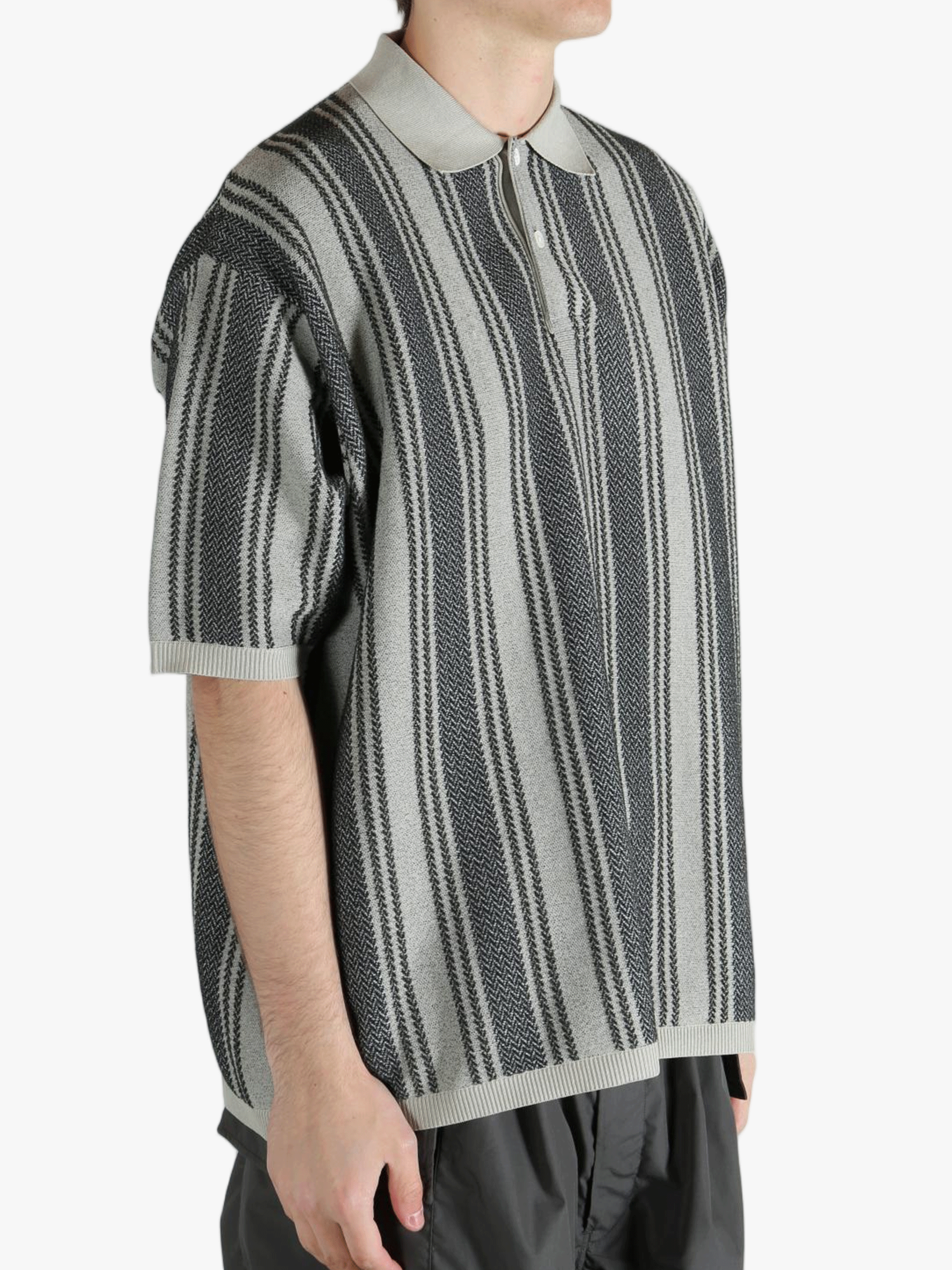 Grey sweat worn by a person, showing the sweat's fit