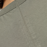 Close up of green t-shirts, showing texture of the Cotton fabric