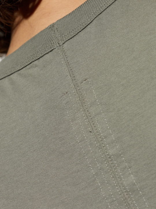Close up of green t-shirts, showing texture of the Cotton fabric