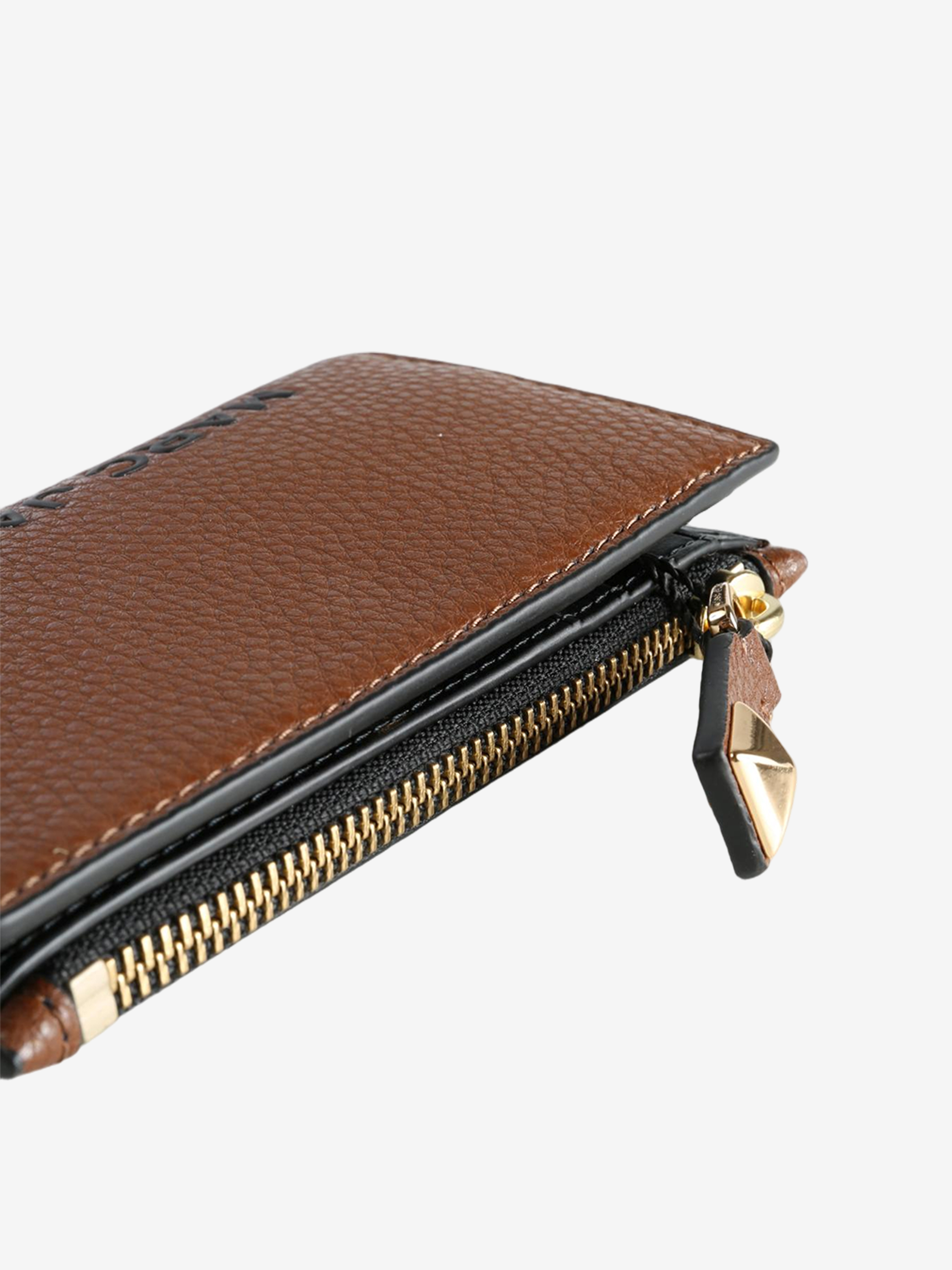 Close up of brown wallet, showing texture of the split cow leather fabric