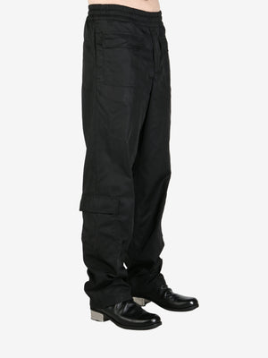 Black pendeen pants worn by a person, showing the pants's fit