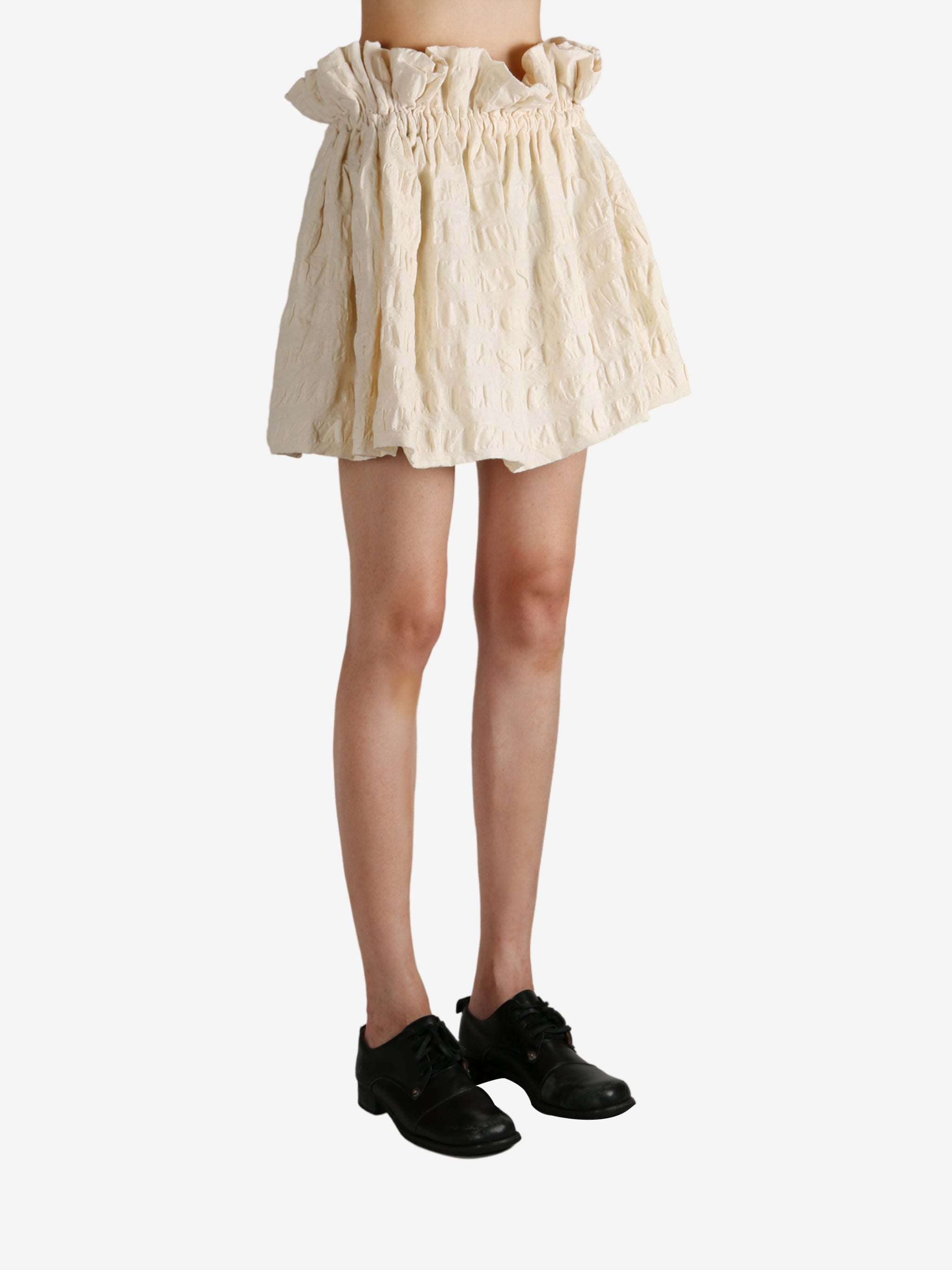 White skirt worn by a person, showing the skirt fit