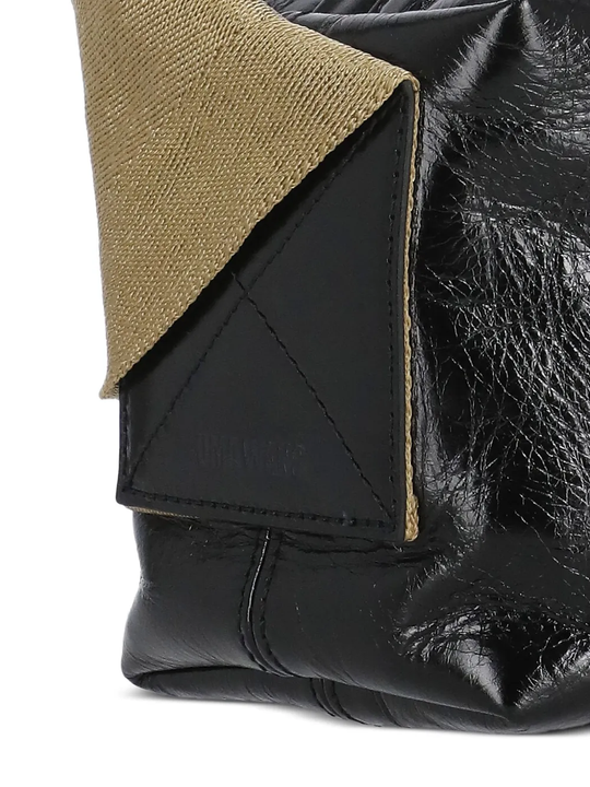 Close up of the black bag, showing texture of the leather fabric