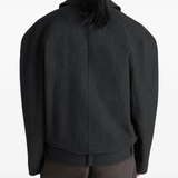 black jacket worn by a person, showing the jacket fit