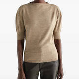 Tan knitwear worn by a person, showing the knitwear fit