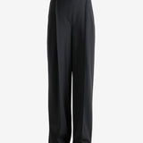 Black pants worn by a person, showing the pants fit