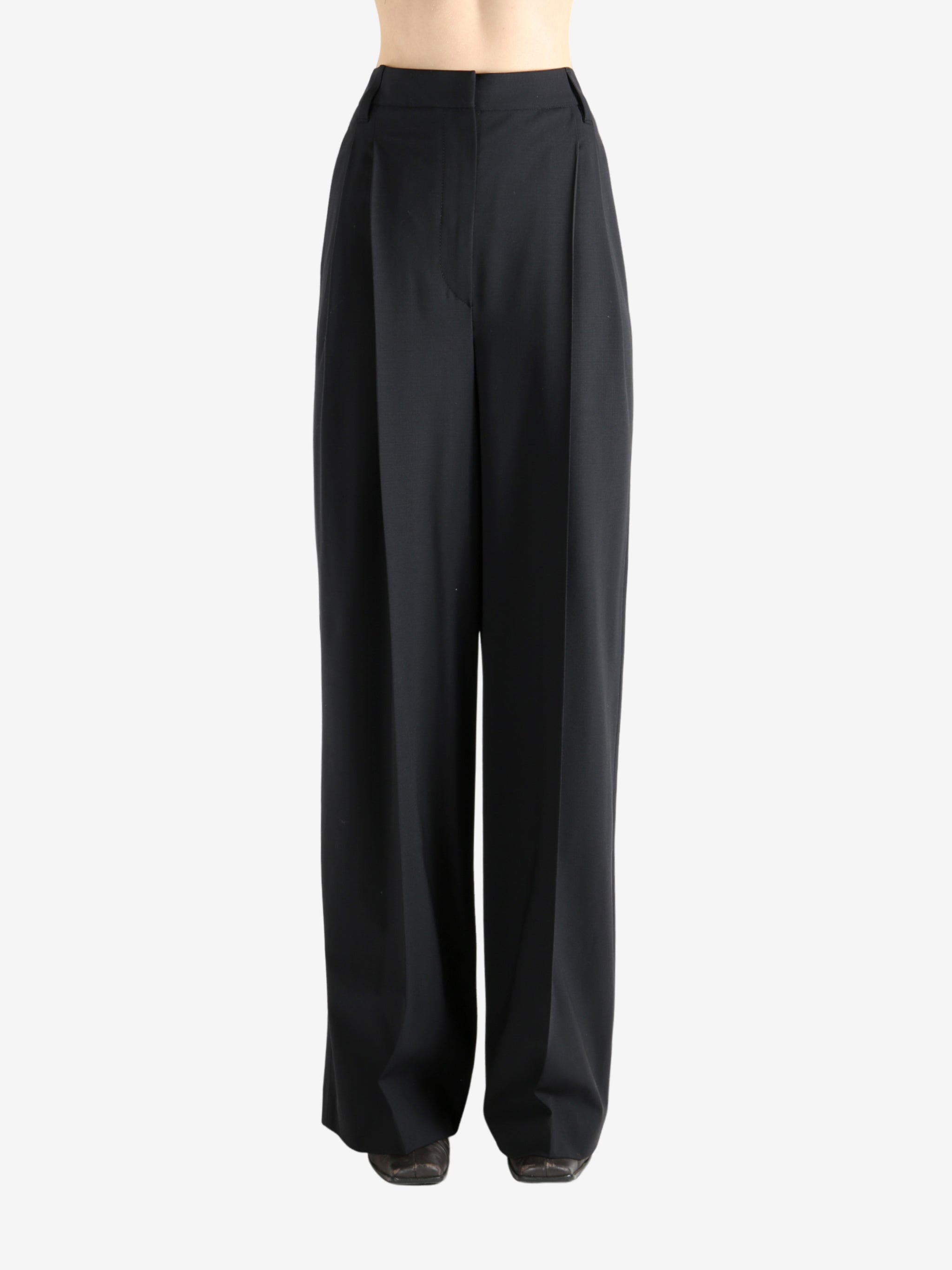 Black pants worn by a person, showing the pants fit