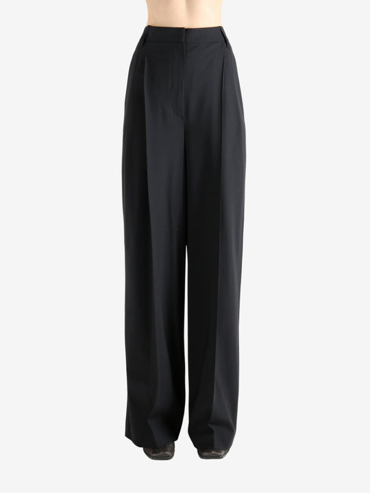 Black pants worn by a person, showing the pants fit