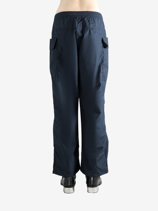 Navy pants worn by a person, showing the pants' fit
