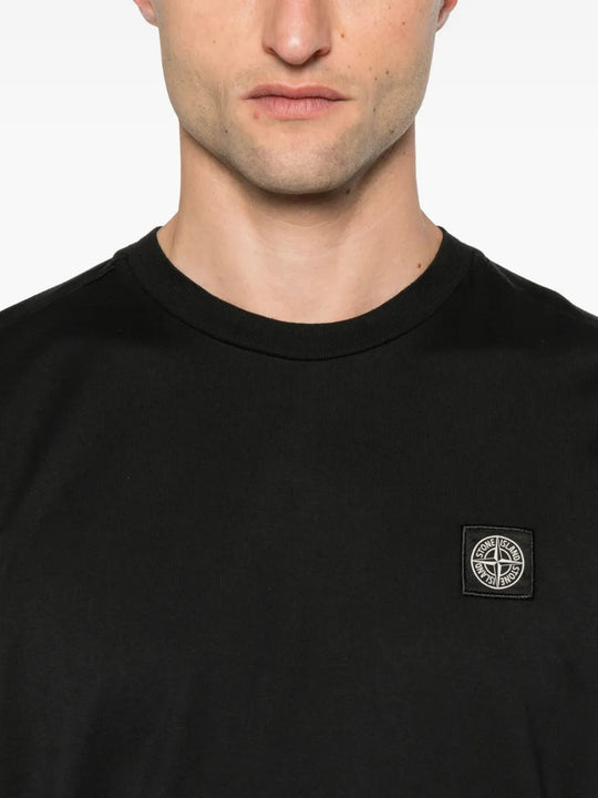 Close up of black t-shirts, showing texture of the cotton fabric