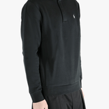 Black pullover worn by a person, showing the pullover's fit