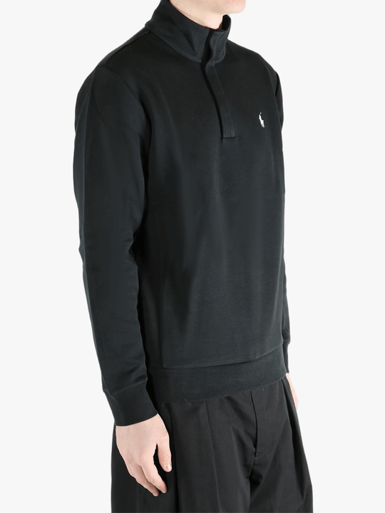 Black pullover worn by a person, showing the pullover's fit