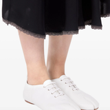 white flats worn by a person, showing the flats fit