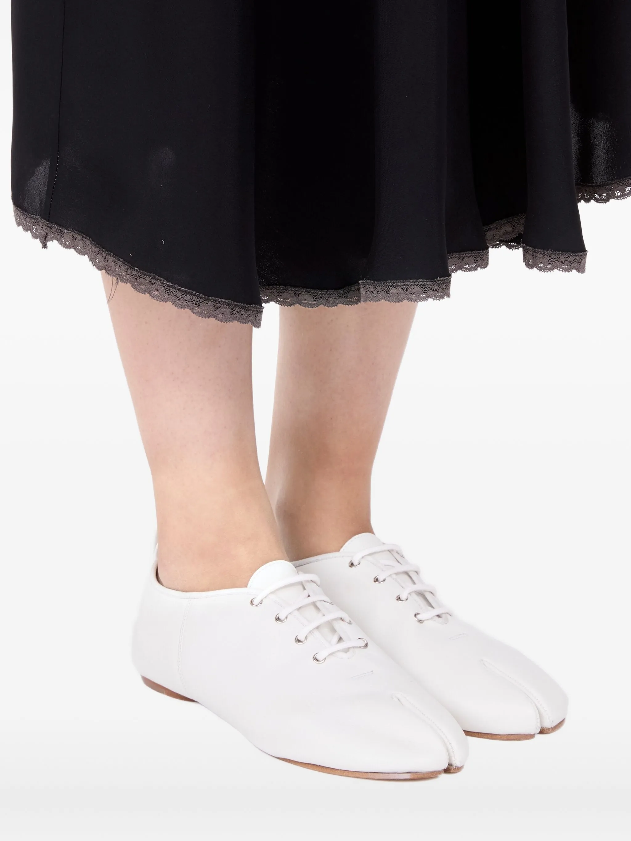 white flats worn by a person, showing the flats fit