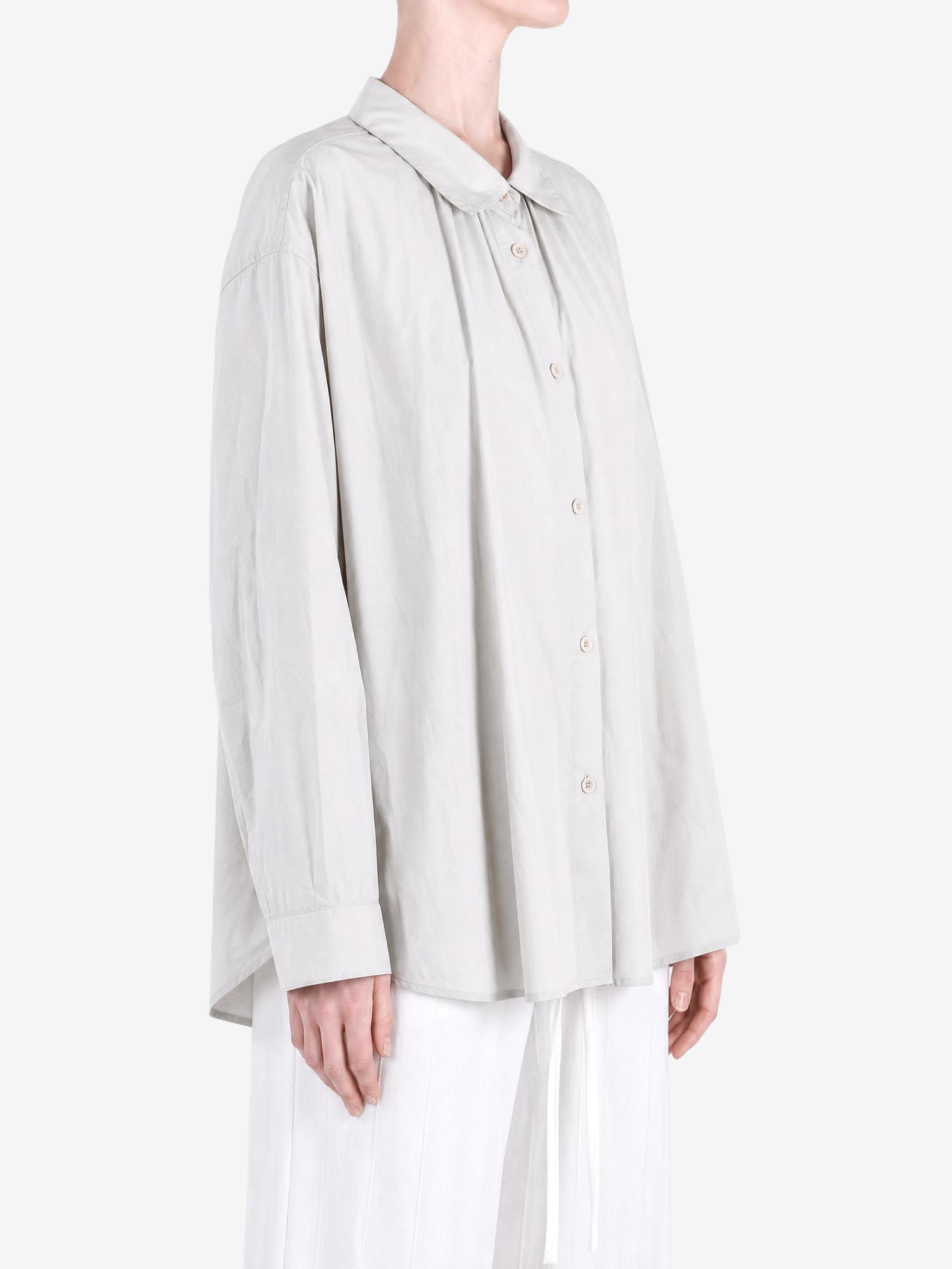 Grey shirt worn by a person, showing the shirt fit
