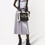 Black bag carried by a person, showing the bag's fit