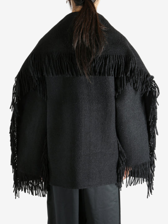 Black jacket worn by a person, showing the jacket's fit