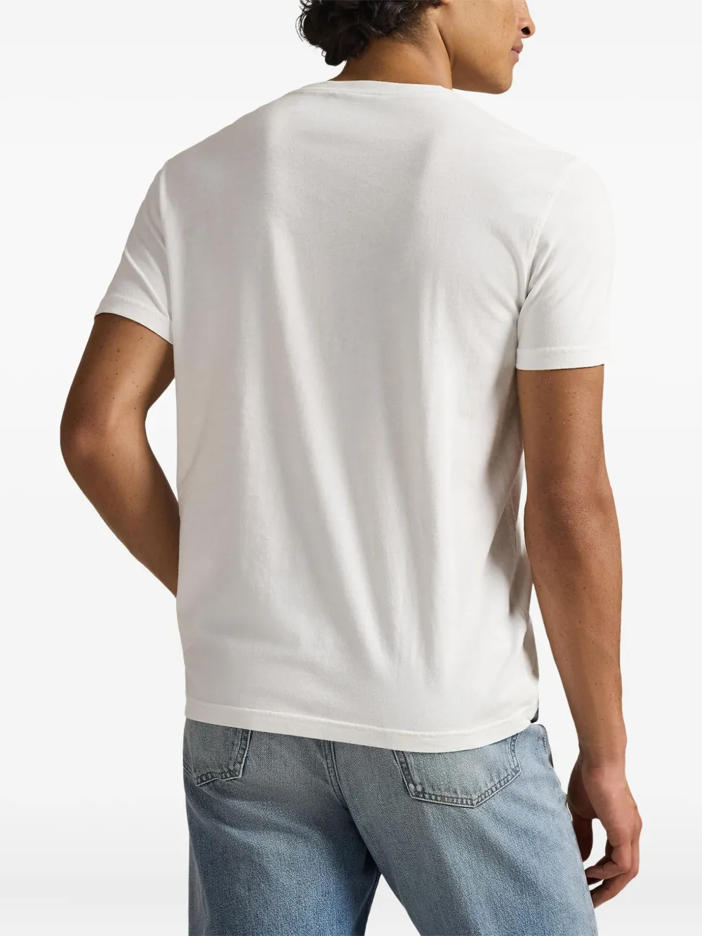 White t-shirt worn by a person, showing the t-shirt fit