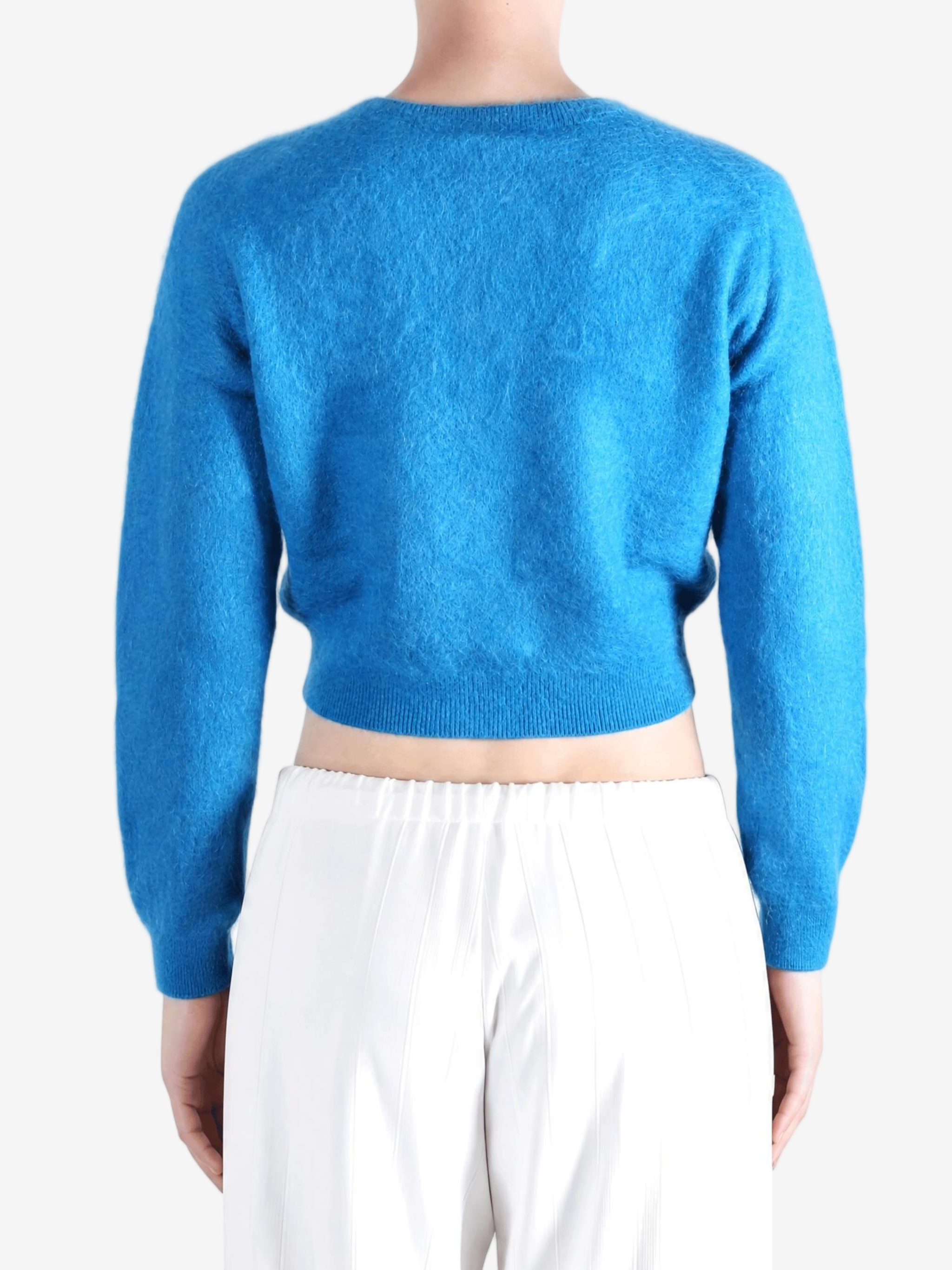 Blue knitwear worn by a person, showing the knitwear fit