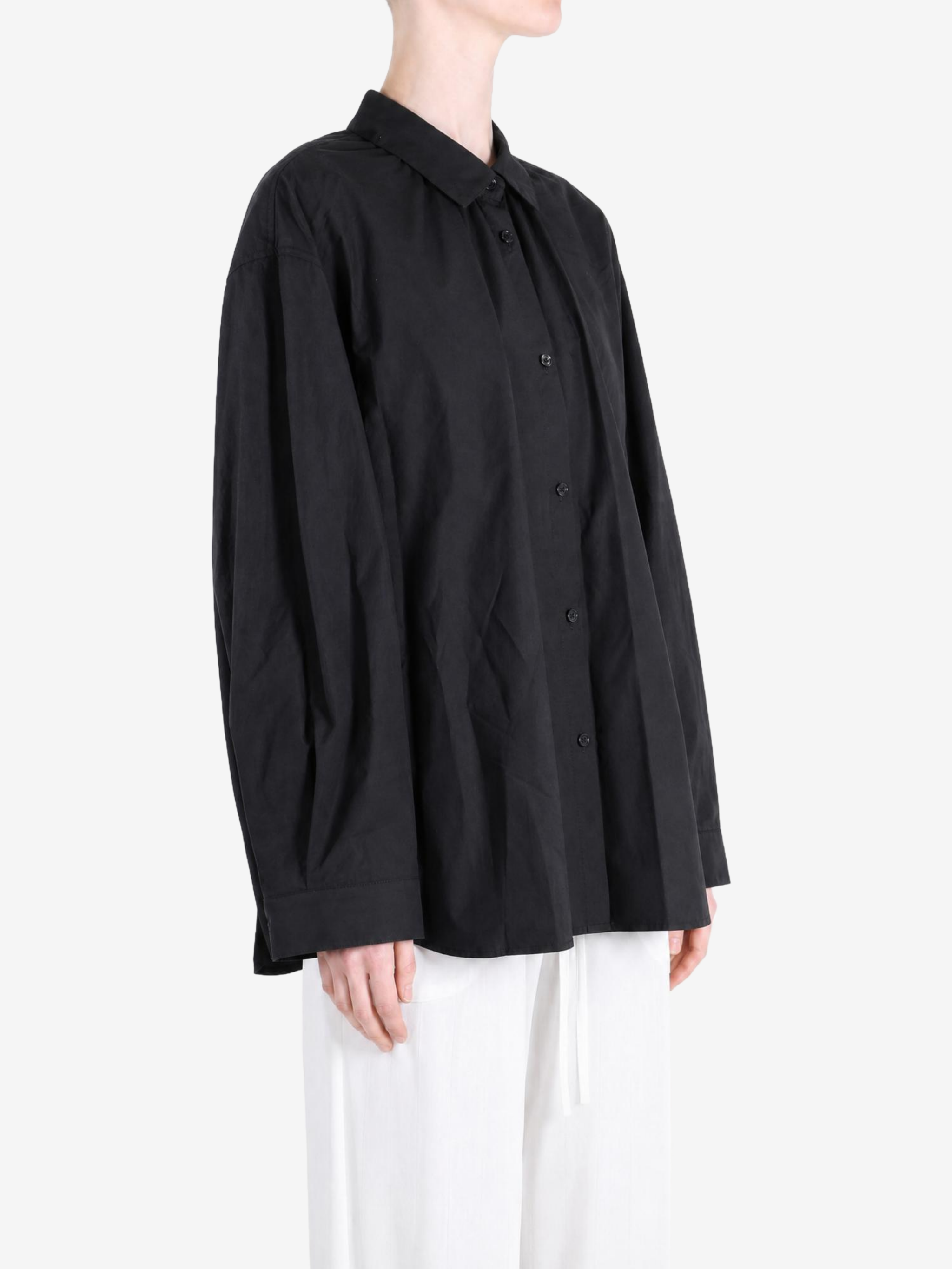 Black shirt worn by a person, showing the shirt fit