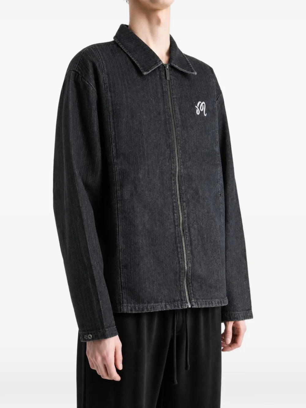 Black jacket worn by a person, showing the jacket fit