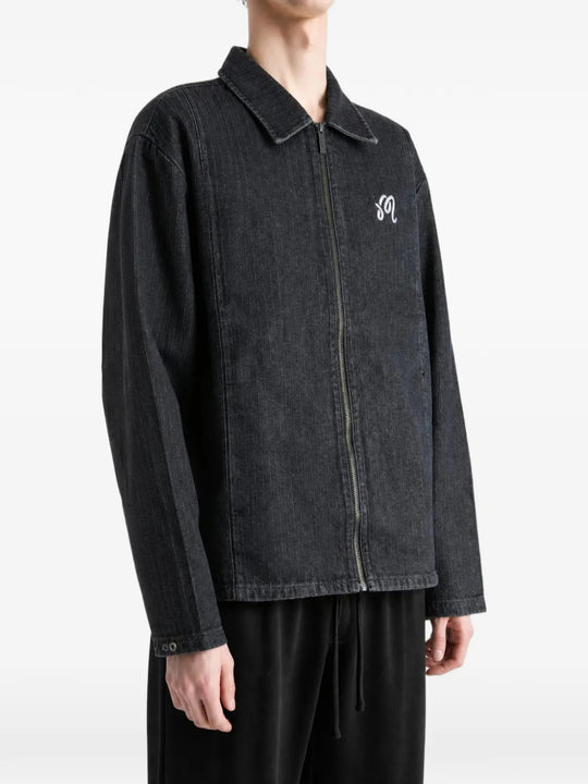 Black jacket worn by a person, showing the jacket fit