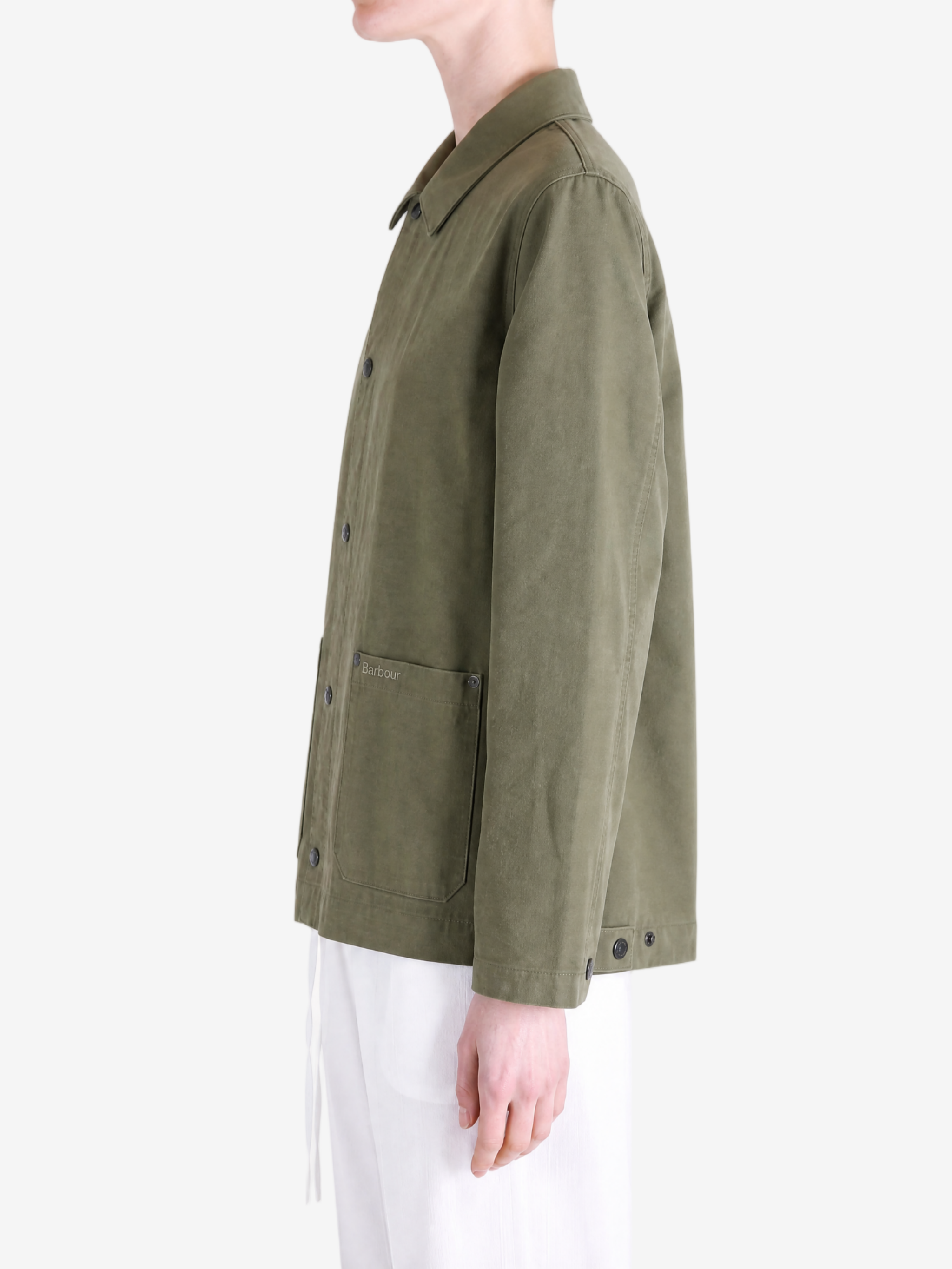 Green jacket worn by a person, showing the jacket fit